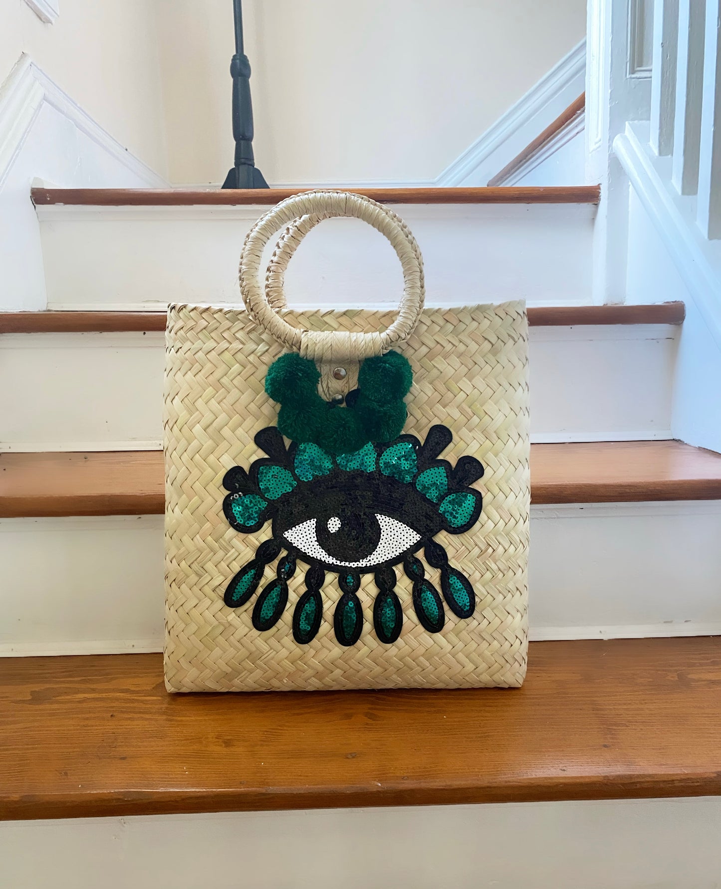 EVIL EYE STRAW POMPÓN BAG